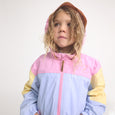 Child wearing a colorful jacket with pink, yellow, and blue sections on a white background