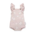 Pink baby romper with ruffled sleeves and white floral patterns on a white background