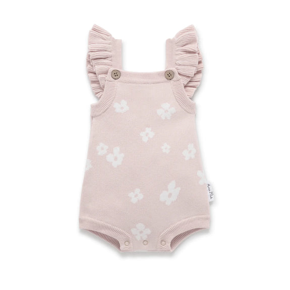 Pink baby romper with ruffled sleeves and white floral patterns on a white background