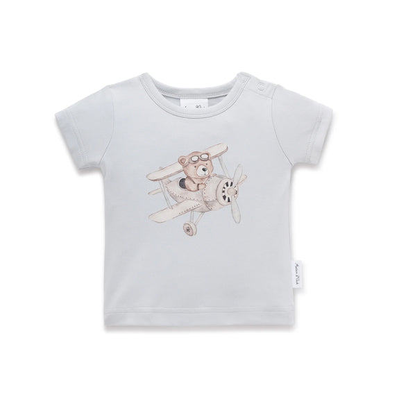 Light blue t-shirt with a teddy bear on an airplane design on a white background