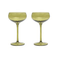 Two green cocktail glasses on a white background