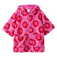 Pink children's towel with red floral pattern on a white background