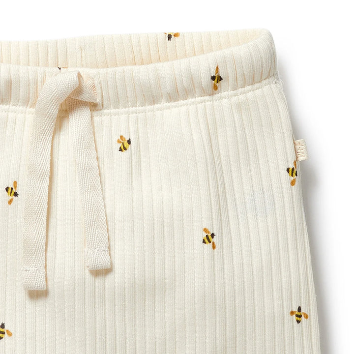 Wilson & Frenchy White ribbed pants with embroidered bees on a white background