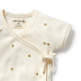 Wilson & Frenchy Baby outfit with embroidered bees on a white background