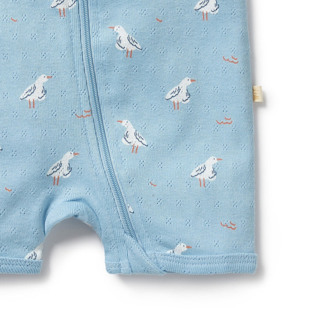 Wilson & Frenchy Blue baby romper with seagull pattern on a white background