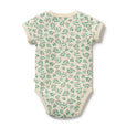 Baby onesie with green leaf pattern on a white background