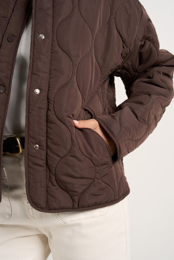 Stay cosy while keeping effortlessly chic in this chocolate quilted puffer jacket. With its lightweight yet warm design, this is the perfect layering piece to transition through the seasons. Available from www.thecollectivenz.com