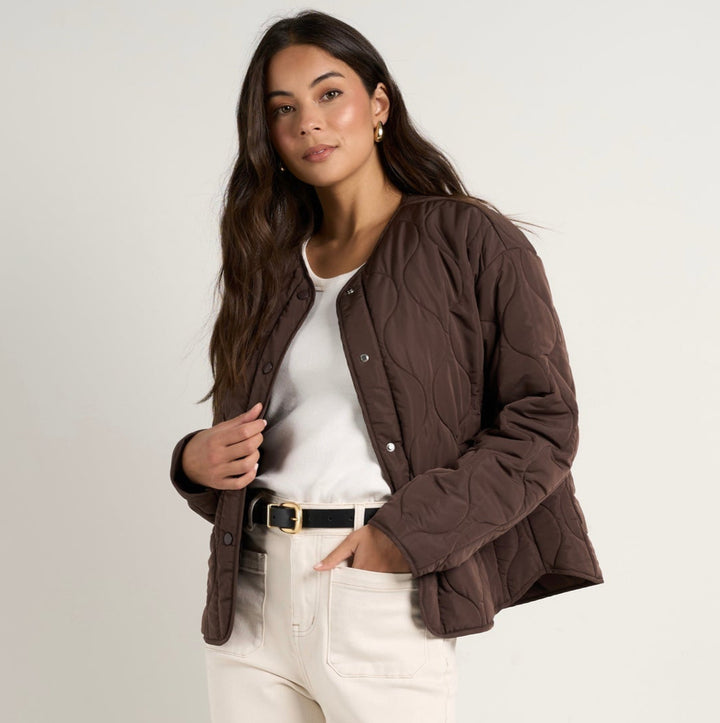 Stay cosy while keeping effortlessly chic in this chocolate quilted puffer jacket. With its lightweight yet warm design, this is the perfect layering piece to transition through the seasons. Available from www.thecollectivenz.com