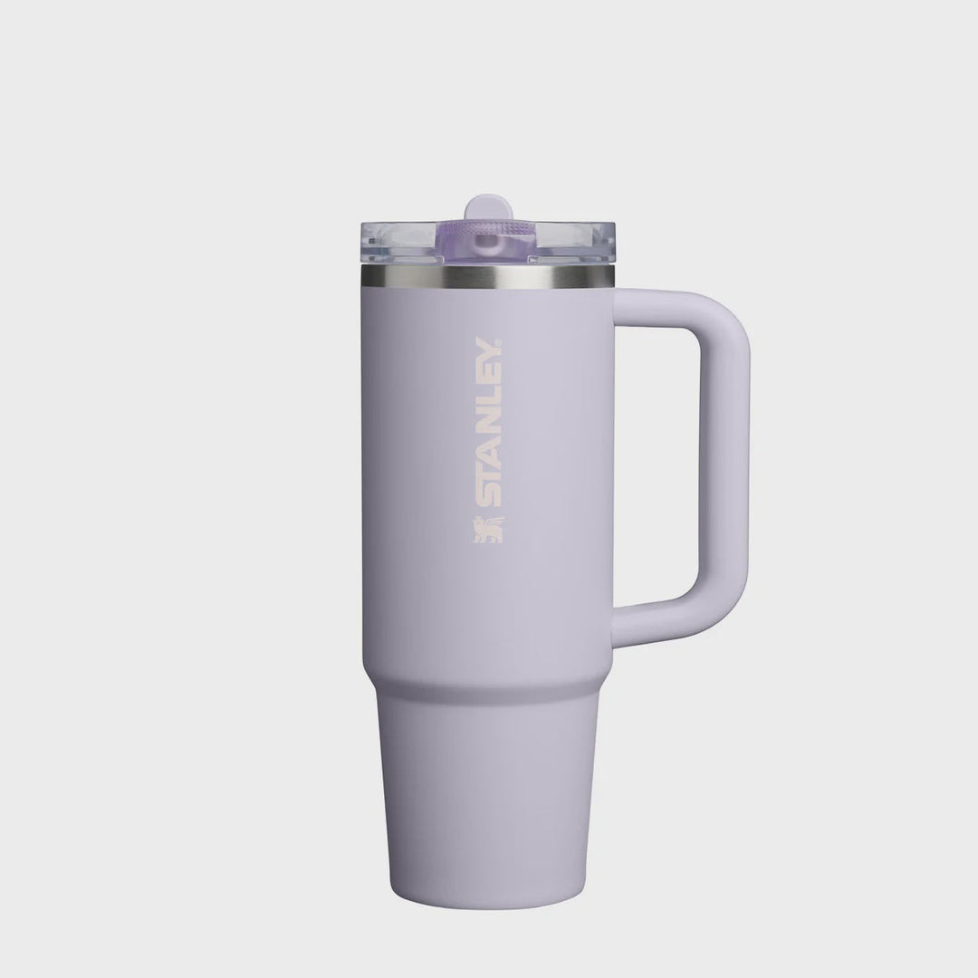 Purple Stanley tumbler with handle on a white background