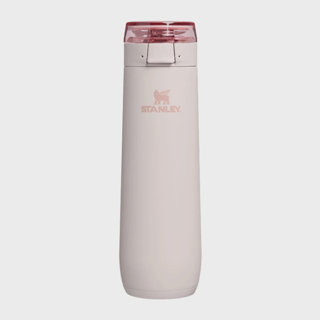A Stanley water bottle with a matte pale pink body and a translucent dark pink lid, shown against a light gray background.