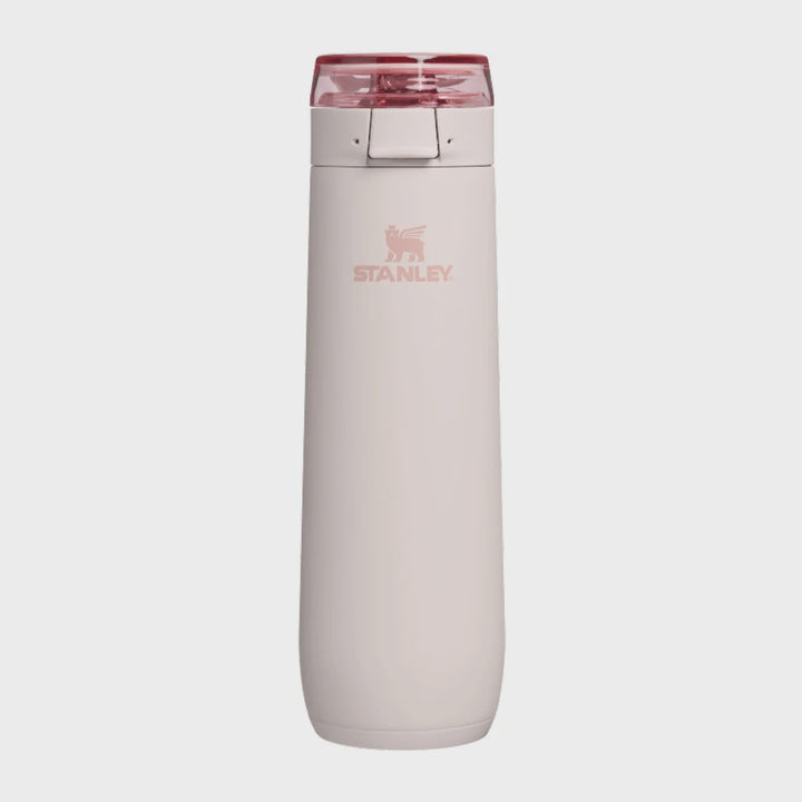 A Stanley water bottle with a matte pale pink body and a translucent dark pink lid, shown against a light gray background.