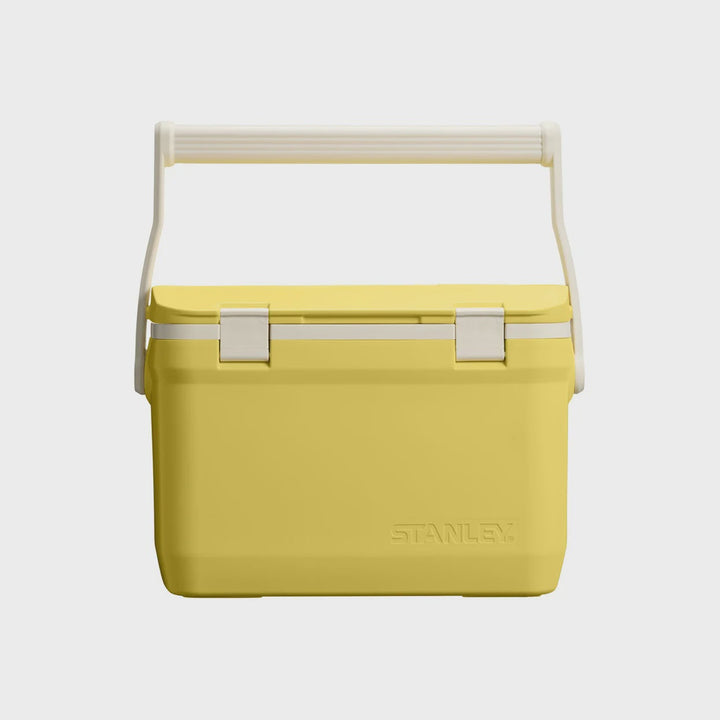 A yellow Stanley cooler with a white handle and white latches, shown against a light gray background.