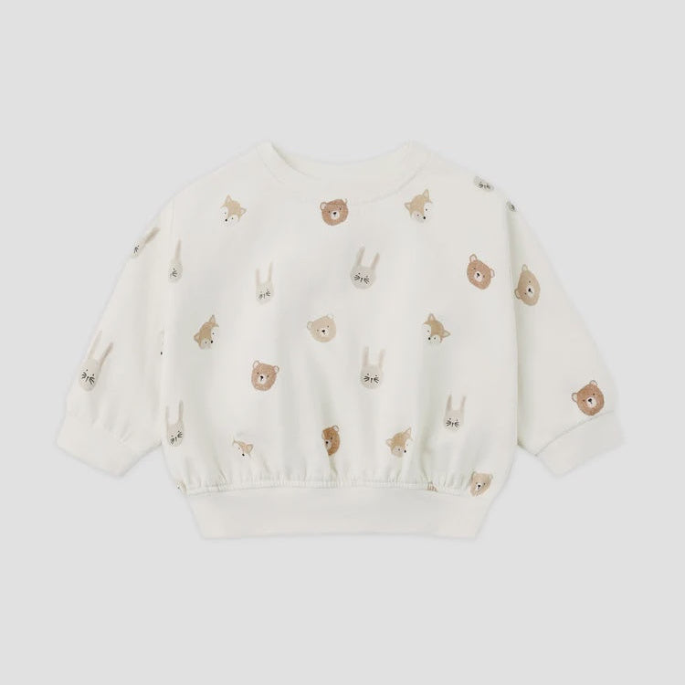 An off-white long-sleeve sweatshirt for toddlers, featuring an all-over print of small embroidered animal faces including bears, rabbits, and foxes in brown and beige tones, displayed on a light gray background.