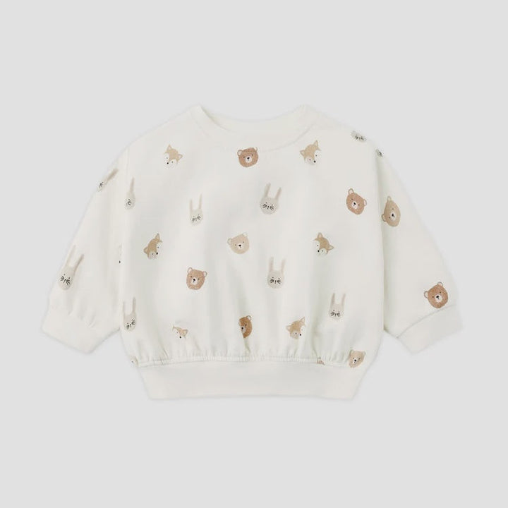 An off-white long-sleeve sweatshirt for toddlers, featuring an all-over print of small embroidered animal faces including bears, rabbits, and foxes in brown and beige tones, displayed on a light gray background.
