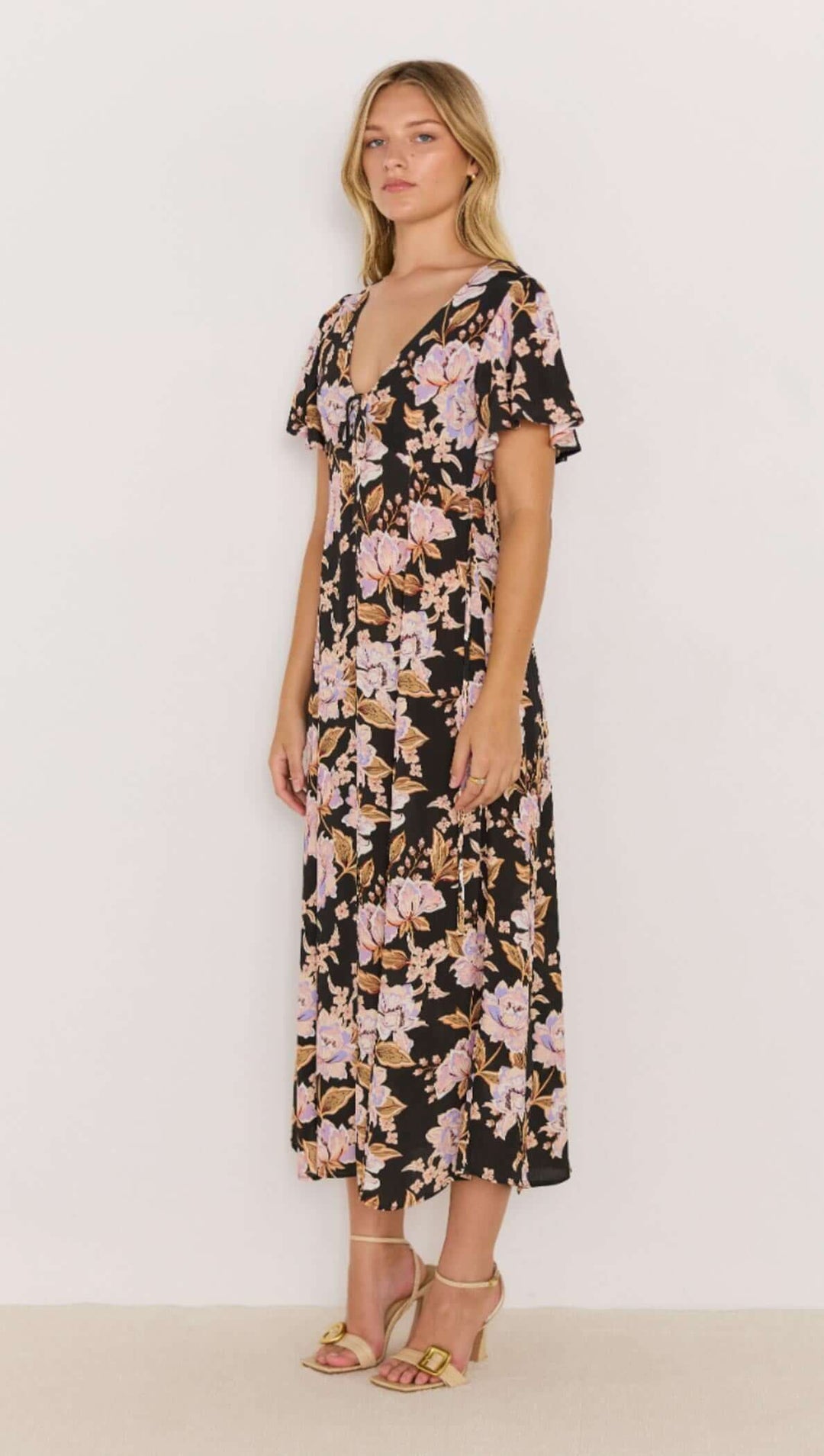 The Willow Midi Dress features a bold floral print on a soft, lightweight fabric that moves with you. With flutter sleeves and a relaxed tie-front detail, it’s the ultimate day-to-night piece. Available from www.thecollectivenz.com