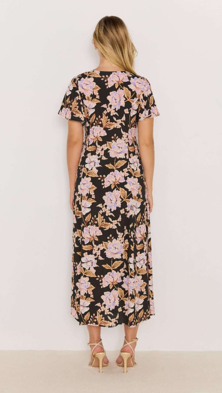 The Willow Midi Dress features a bold floral print on a soft, lightweight fabric that moves with you. With flutter sleeves and a relaxed tie-front detail, it’s the ultimate day-to-night piece. Available from www.thecollectivenz.com
