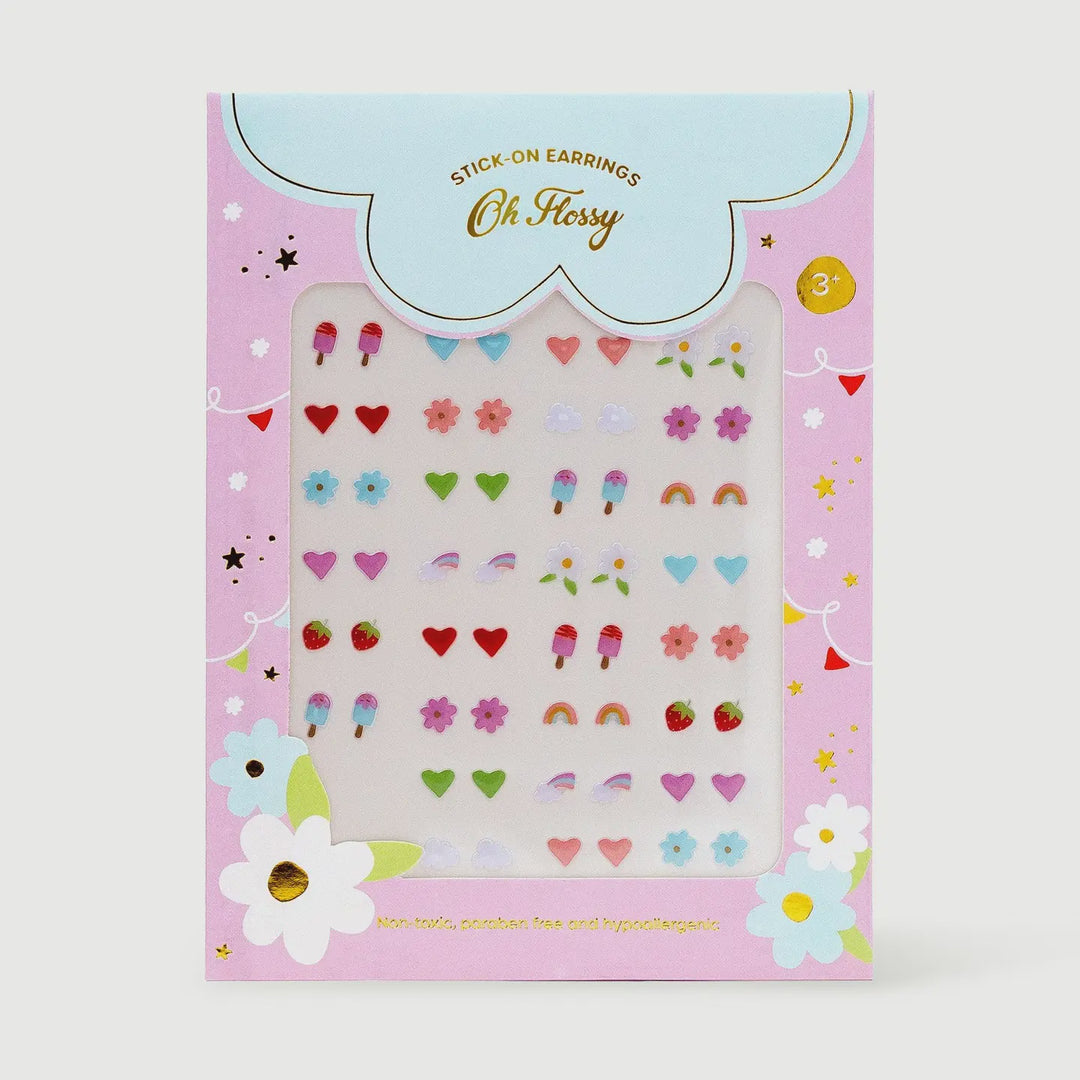 Oh Fussy Stick-On Earrings sticker pack in a pink box with a clear window showing colorful heart, flower, strawberry, and rainbow earring stickers.