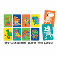 Colorful card game with dinosaur illustrations and text 'Spot a skeleton, slap it, win cards!' on a white background.