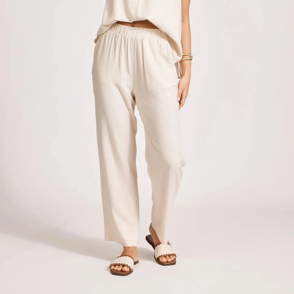 Woman wearing Eb & Ive high-waisted pants on a plain background