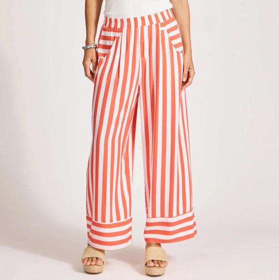Woman wearing a white sleeveless top and red and white eb & ive striped pants on a light background
