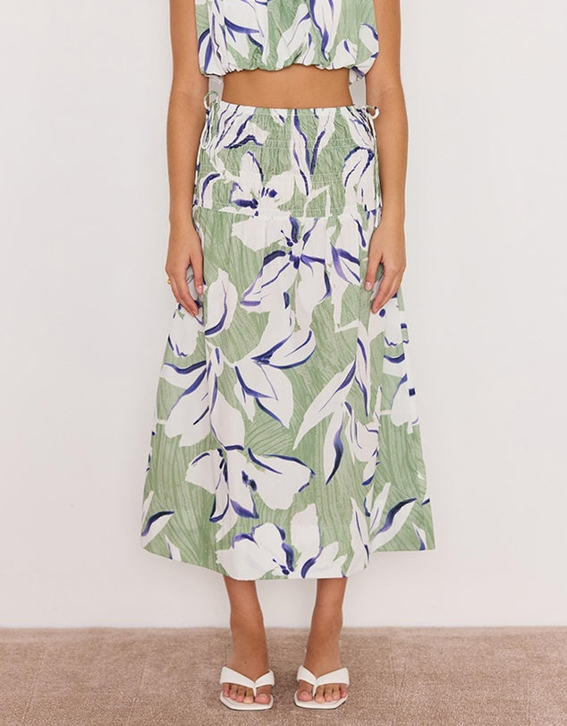 Person wearing a floral dress with a white background