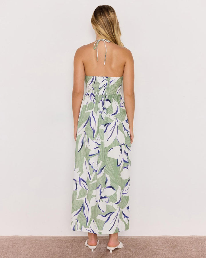 Woman wearing a strapless floral dress with a white background