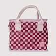 Checkered handbag with pink and red pattern on a light gray background