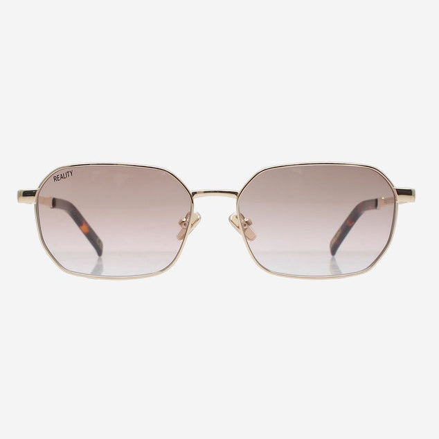 Sunglasses with gold frame and gradient lenses on a white background