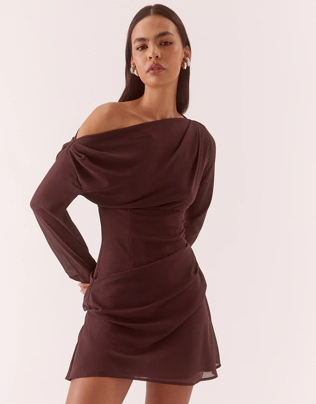 Woman wearing a brown off-shoulder dress on a white background