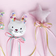 Decorative rabbit head with colorful flowers and ribbons on a pink background