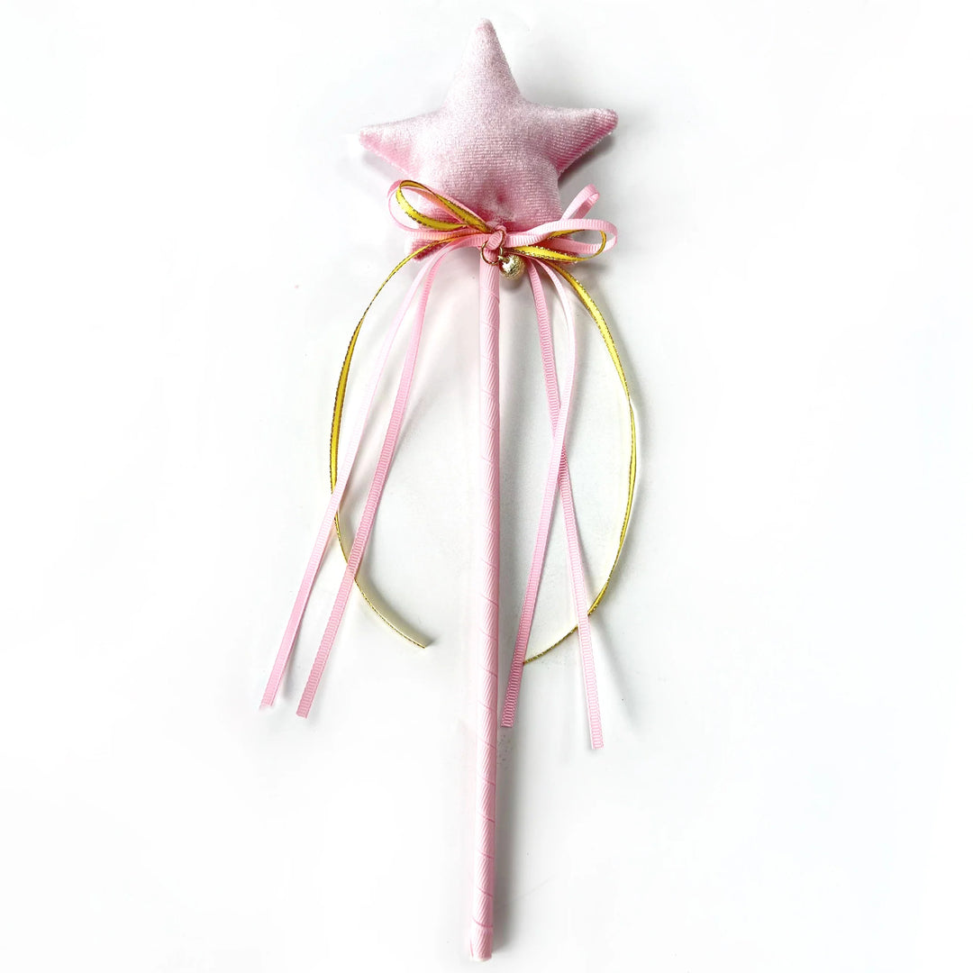 Pink star-shaped wand with ribbons on a white background