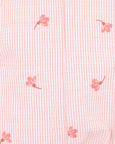 Pink floral pattern on a textured fabric background