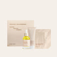 Pregnancy spa experience product set including a box, bottle, tube, and sheet mask on a white background.