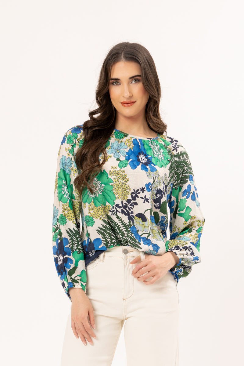 Woman wearing a floral blouse with a white background
