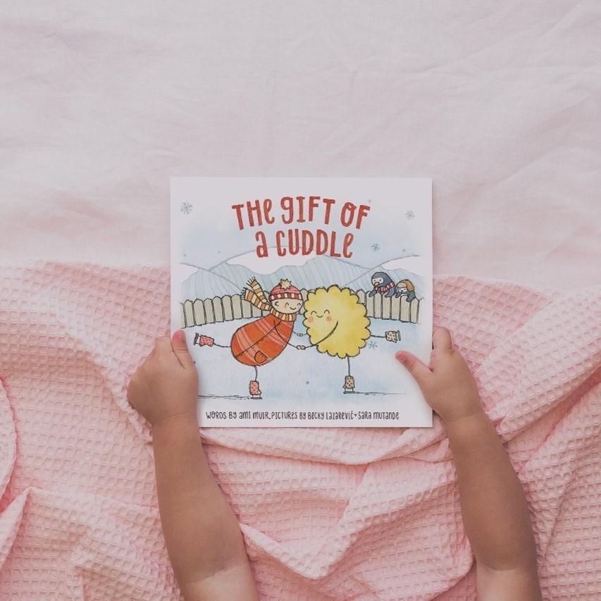 The gift of a cuddle board book is Told by a grown up trying to make the perfect cuddle for their little one, this book is about all of the wonderful things cuddles can do. Available from www.thecollectivenz.com