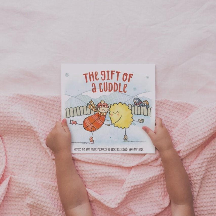 The gift of a cuddle board book is Told by a grown up trying to make the perfect cuddle for their little one, this book is about all of the wonderful things cuddles can do. Available from www.thecollectivenz.com