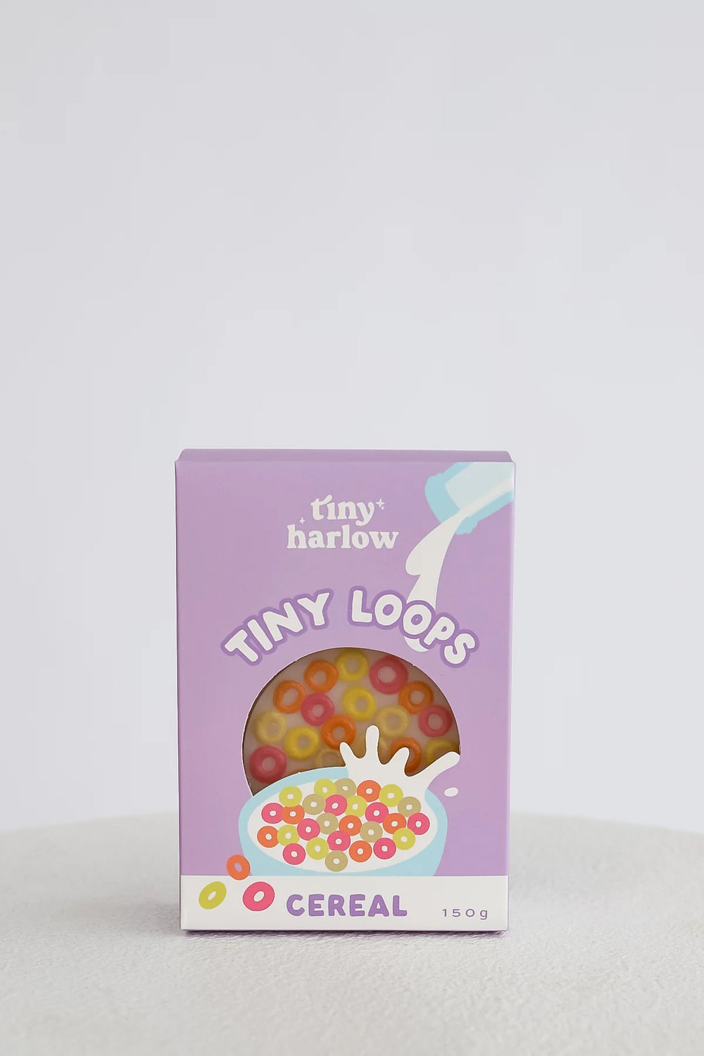 Box of tiny loops cereal with a purple background
