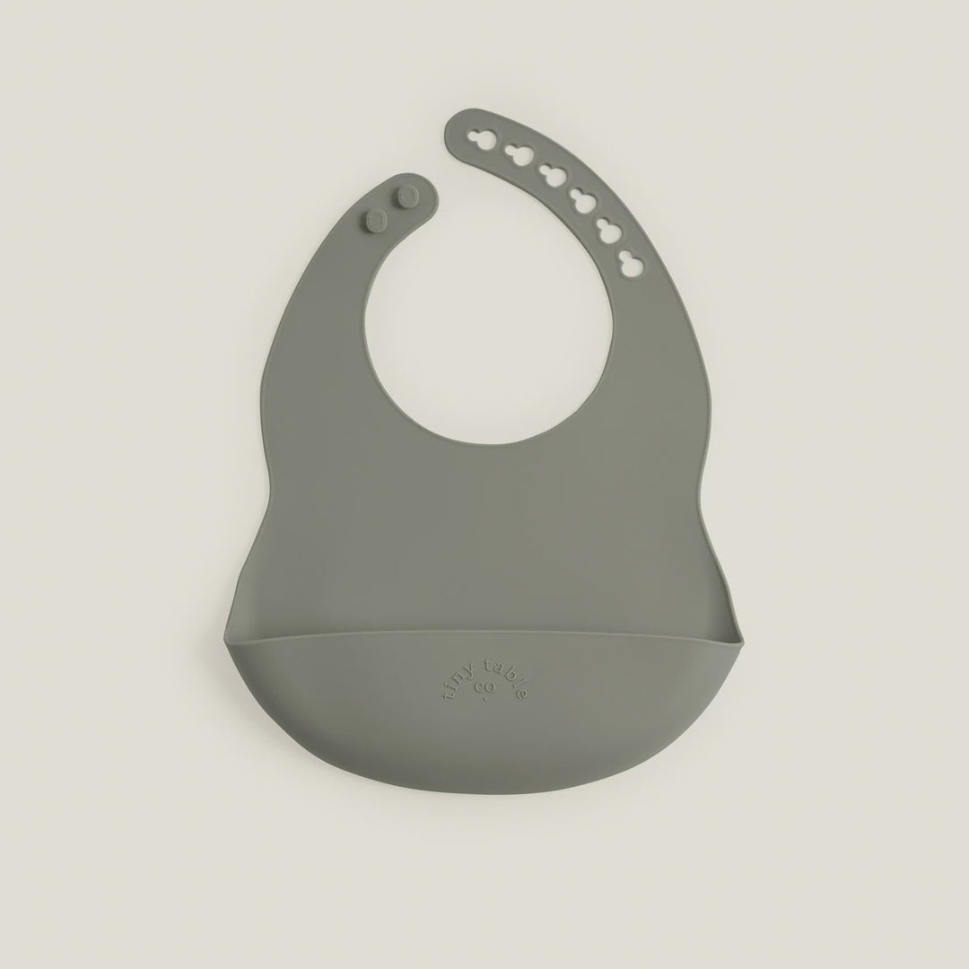 Gray silicone bib on a light beige background