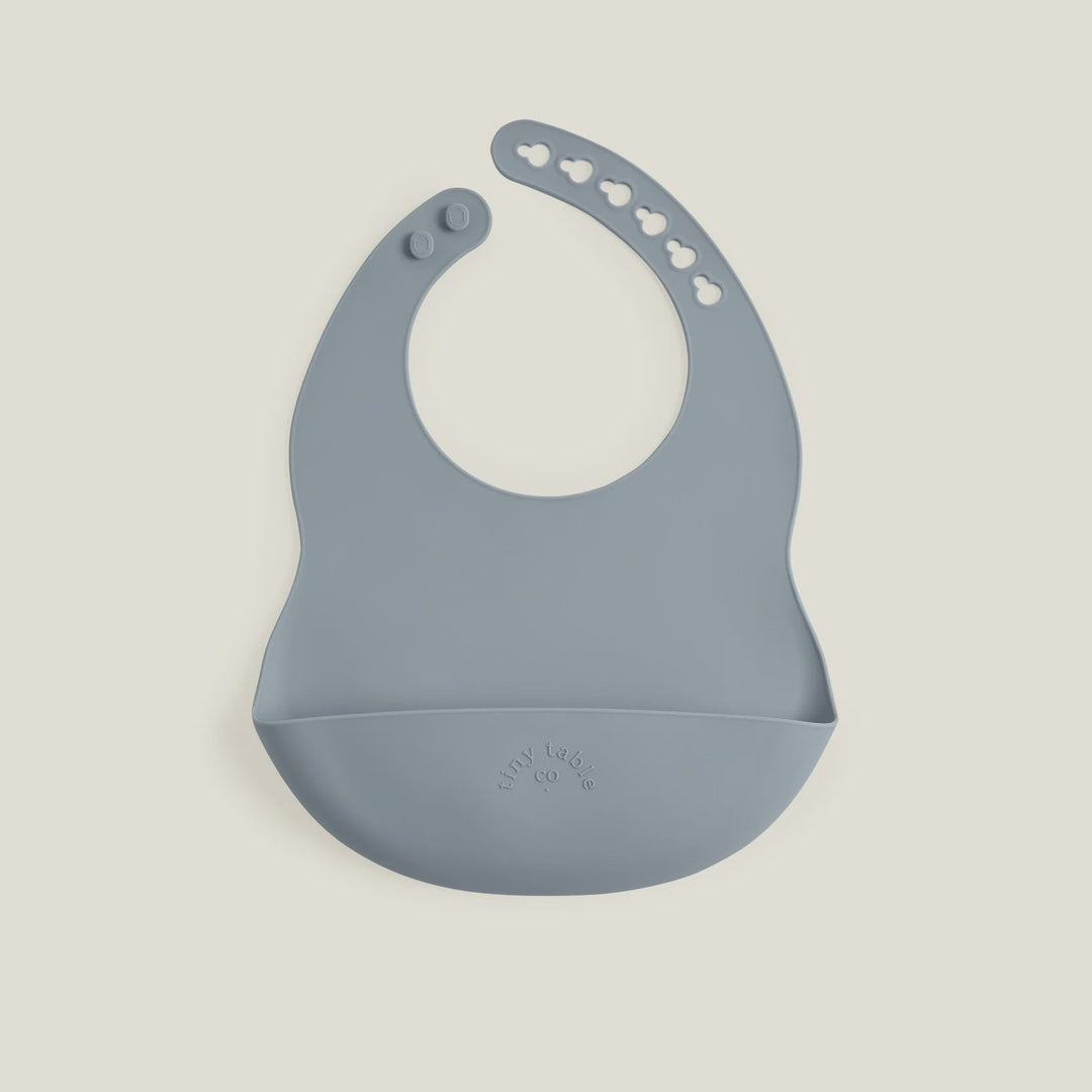 Blue silicone bib on a beige background