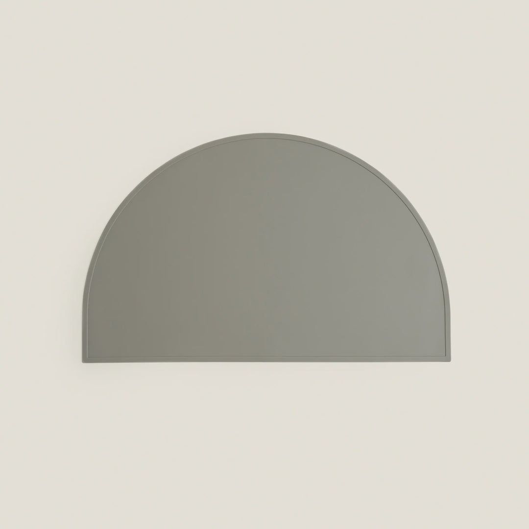 Gray half-circle object on a beige background