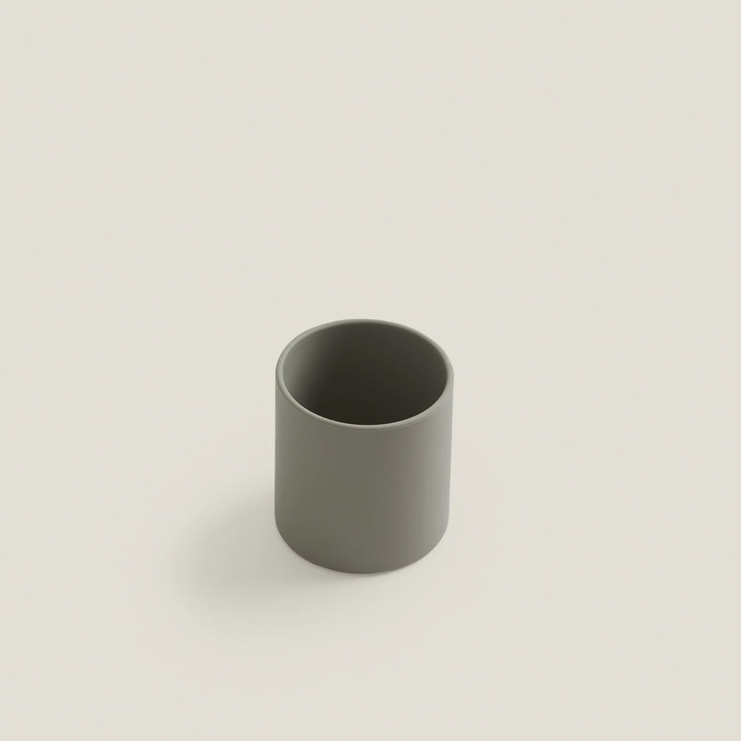 Gray ceramic cup on a light beige background