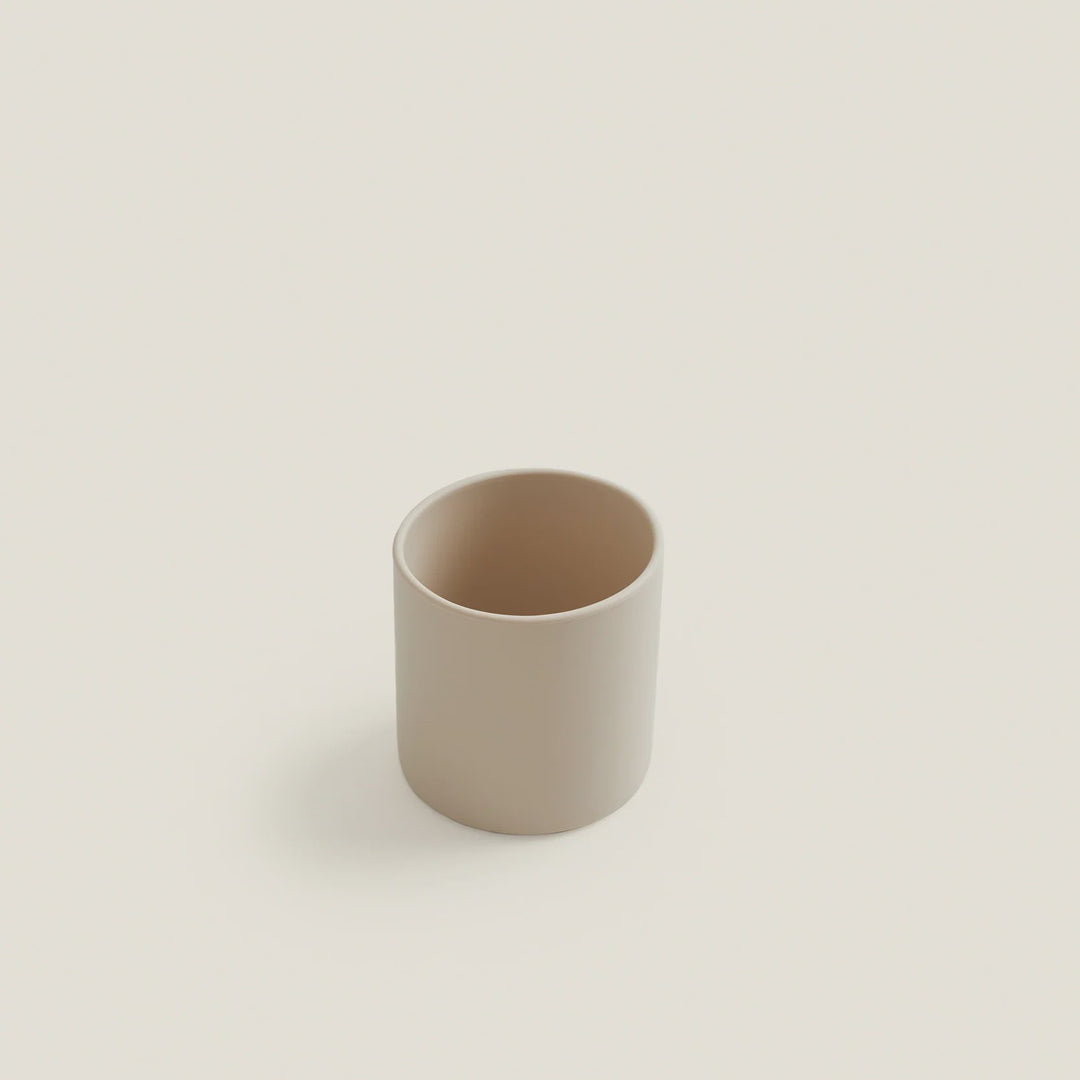 Beige ceramic cup on a light beige background