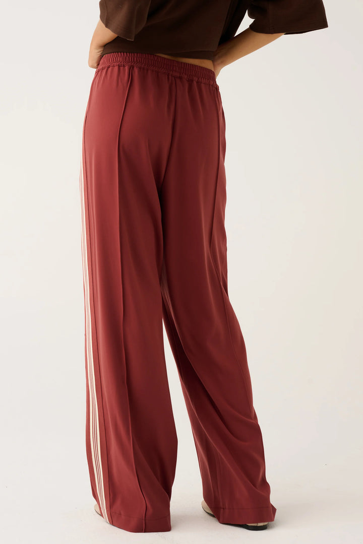 Maroon wide-leg pants worn by a person on a white background
