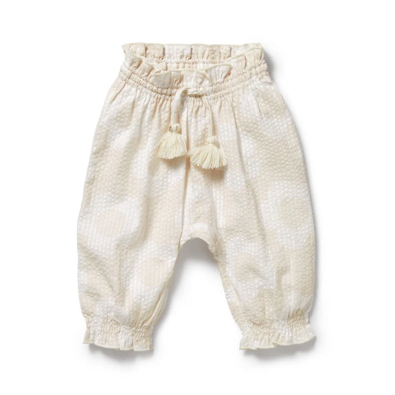White Wilson & Frenchy baby pants with tassels on a white background