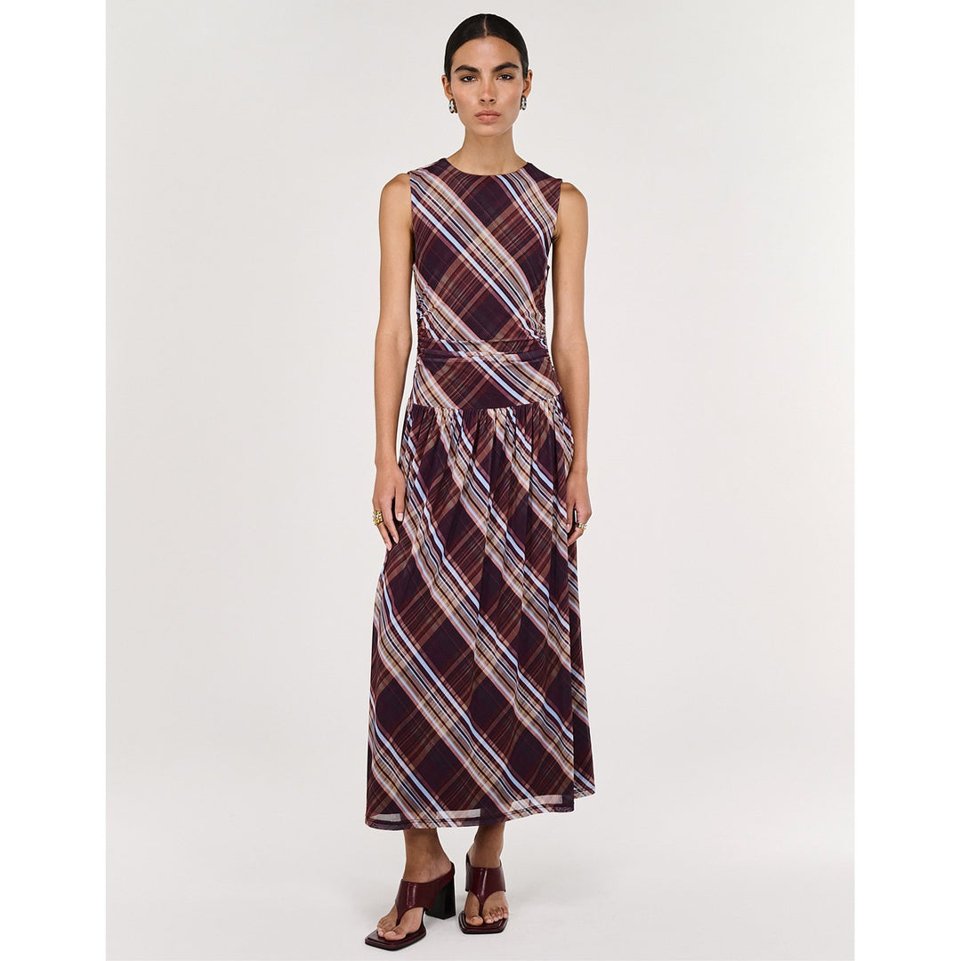 Woman wearing a plaid dress on a white background