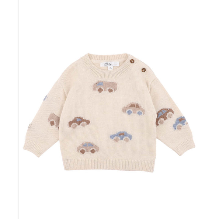 Beige sweater with embroidered car designs on a white background