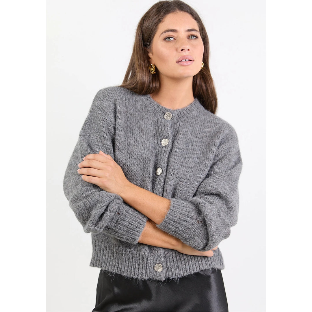 Woman wearing a gray cardigan on a white background
