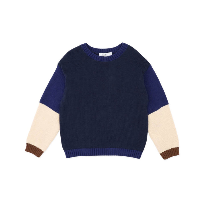 Color-blocked sweater with navy, beige, and brown sleeves on a white background