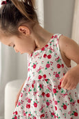 Child wearing a sleeveless Milky dress with cherry pattern against a neutral background
