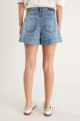 Denim shorts worn by a person on a white background
